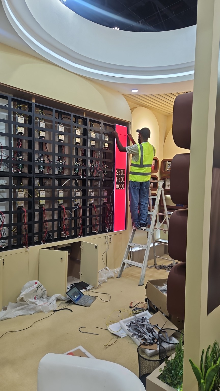 LED screen installation work in progress for an exhibition booth at ADNEC Abu Dhabi